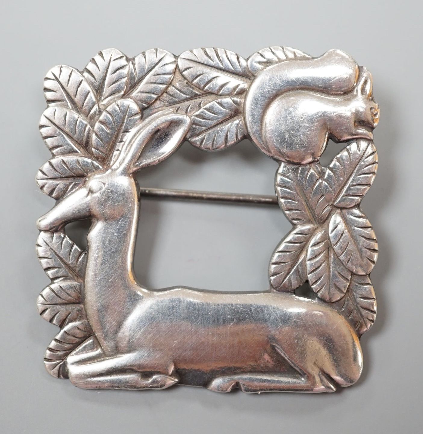 A Georg Jensen sterling 'recumbent deer with squirrel' square brooch, no. 318,36mm.